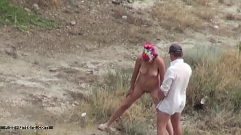 couple teasing voyeurs on nude beach
